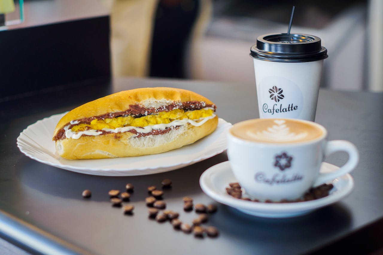 Appealing setup of a sandwich and latte art coffee at Cafelatte, perfect for a snack or breakfast.